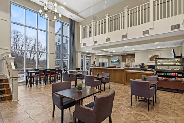 Bright common area with seating and large windows