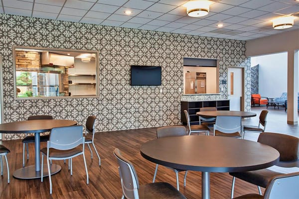 Modern dining area with tables and decorative wall
