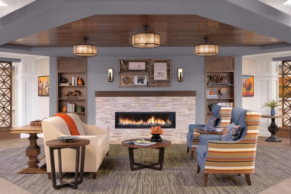 Bright and welcoming common area with seating and fireplace