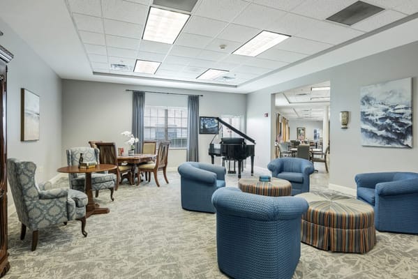 Comfortable seating area in the living room with a piano and dining table.