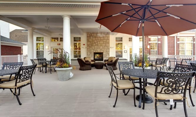 Outdoor patio area with seating and shade.