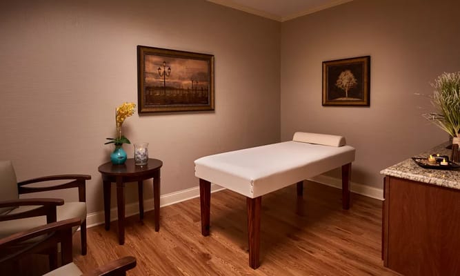 Massage therapy room with massage table and decor
