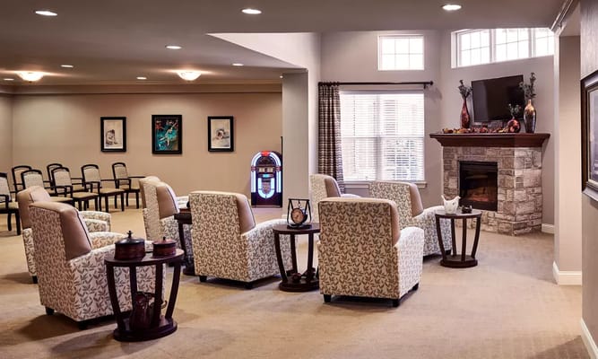 Common area with chairs and a fireplace in a cozy setting