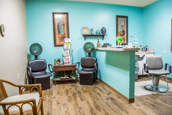 Salon area with chairs and hairdryers