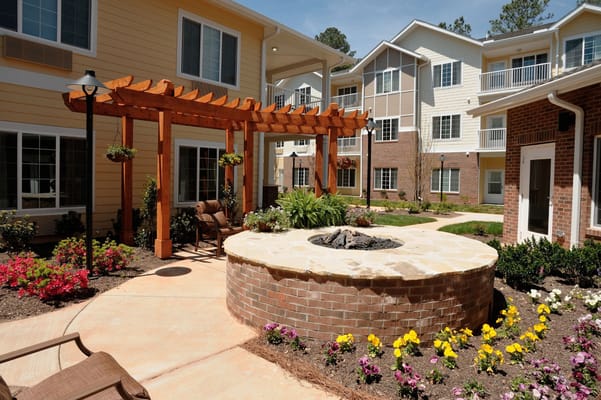 Beautiful courtyard with a fire pit and flowers at Whispering Pines
