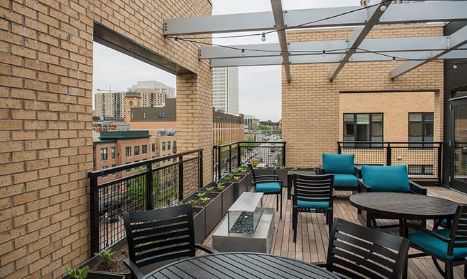 Outdoor patio area with seating and greenery