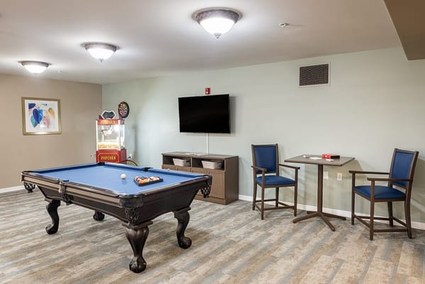 Activity room with a pool table and seating area