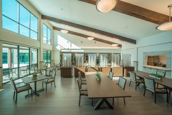 Bright dining area with large windows and modern furniture