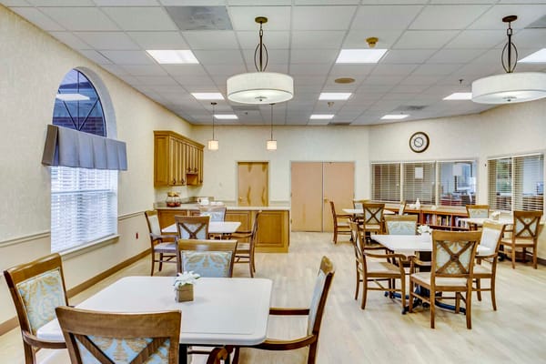 Bright dining room with tables and chairs set up