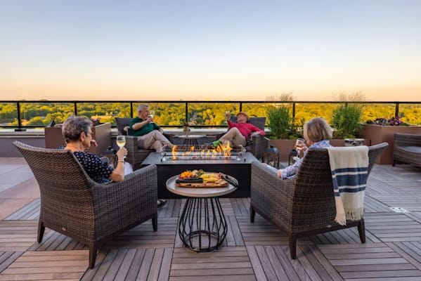 Residents enjoying drinks on a rooftop terrace