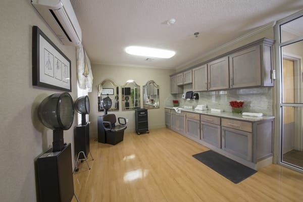 Hair salon area with styling chairs and mirrors