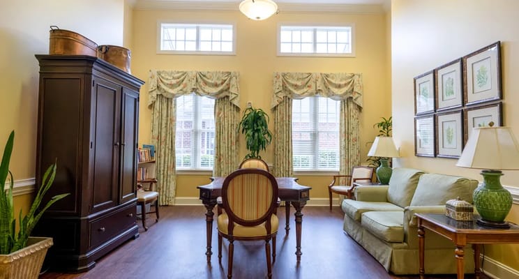 Bright living room with a seating area and large windows