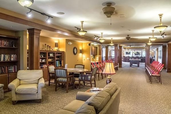 Interior view of a common area with seating and bookshelves