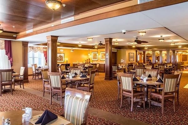 Dining area with tables and chairs set for meals