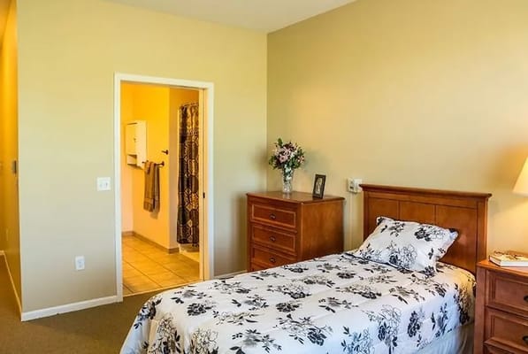 Cozy resident room with floral bedding and decor