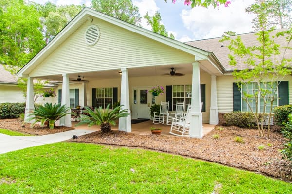 Exterior view of the facility with a porch and gardens