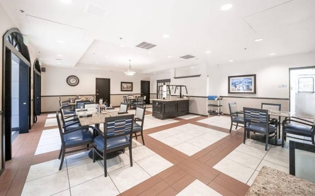 Spacious dining area with tables and chairs in Park Lane Senior Living