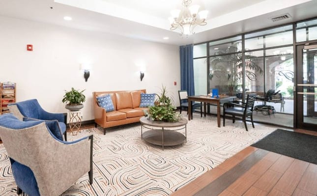 Comfortable seating area in the lobby with plants and a coffee table