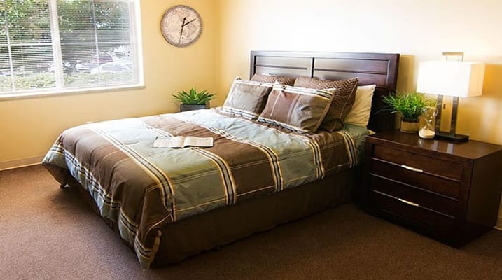 Private resident room with a bed and nightstand