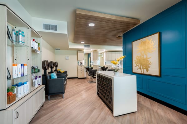 Interior of a salon area with styling chairs and products