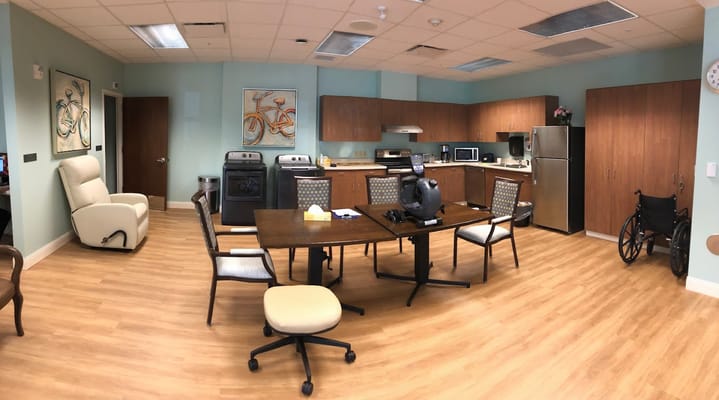 A common area featuring a dining table and kitchenette.