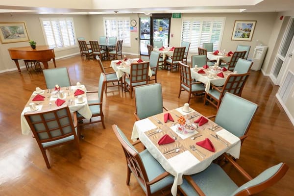 Dining area set up for a meal with tables and chairs