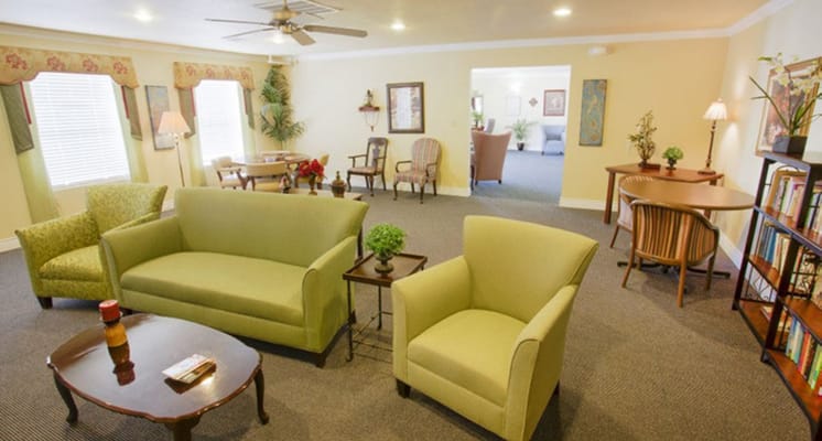 Cozy living area with green chairs and wooden furniture
