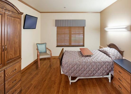 Private resident room with a bed and seating area
