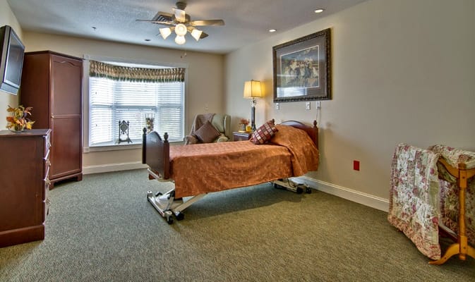 Cozy private resident room with a bed and chair