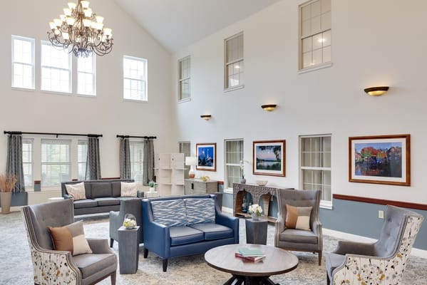 Bright and modern living room with comfortable seating and artwork.