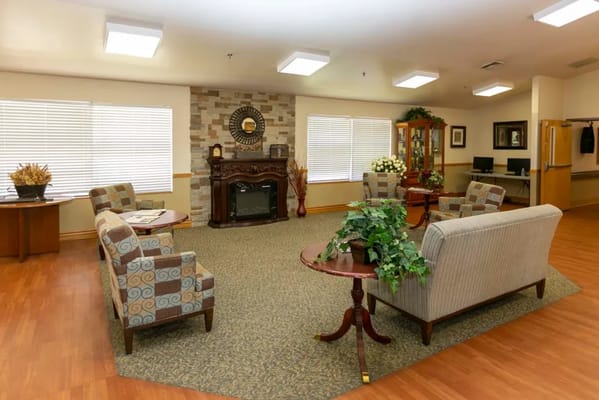 Comfortable living room with seating and a fireplace.