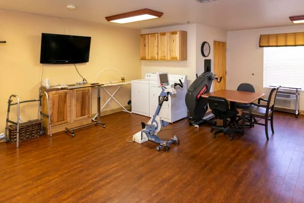 Exercise room featuring workout equipment and a laundry area.