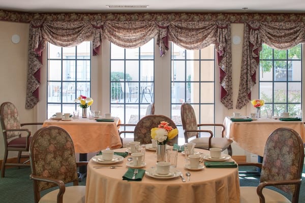 Cozy dining area with set tables and fresh flowers
