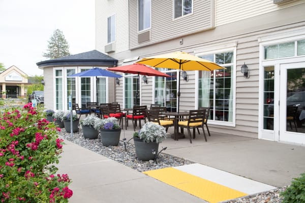 Outdoor seating area with colorful umbrellas and flowers