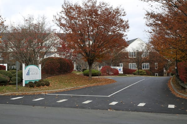 Entrance of Benchmark Senior Living at Hamden in autumn