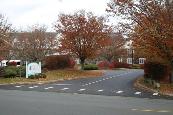 Entrance to Benchmark Senior Living at Hamden in autumn