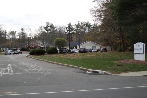 Exterior view of Meadow Mills at Whitney Center with parking