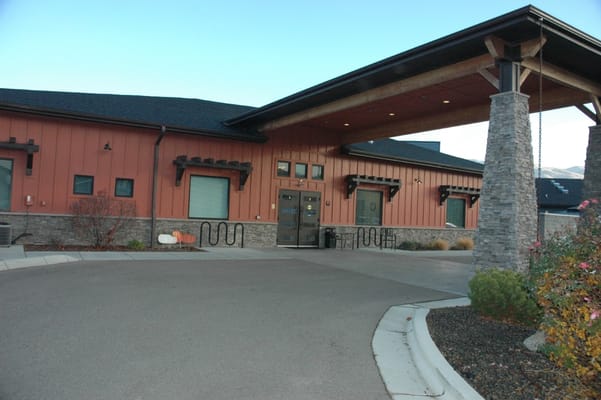 Entrance of a senior living facility with stone and wood features