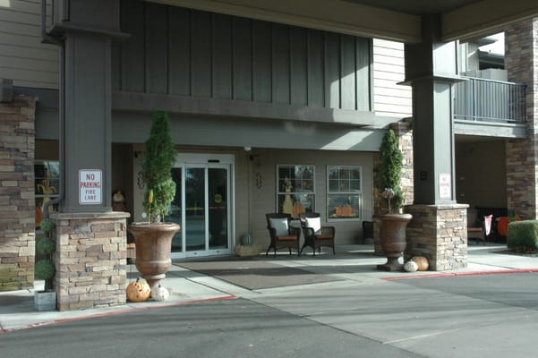 Entrance of a senior living facility with seasonal decorations