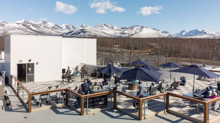 Residents enjoying a live music performance on a rooftop terrace