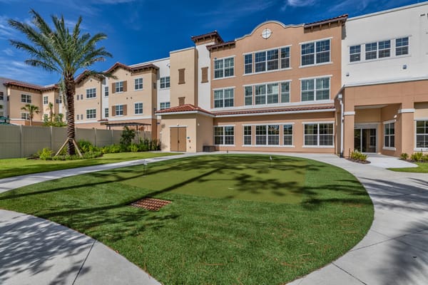 Outdoor area with green space and palm trees