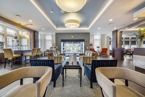 Bright common area with seating and large windows