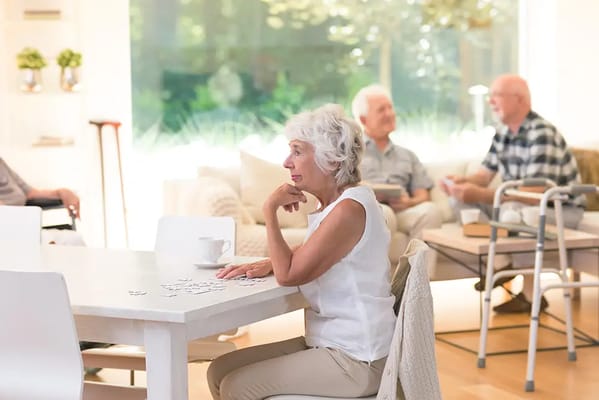 Residents engaging in conversation in a bright common area