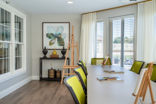 Bright and inviting common area with art easels