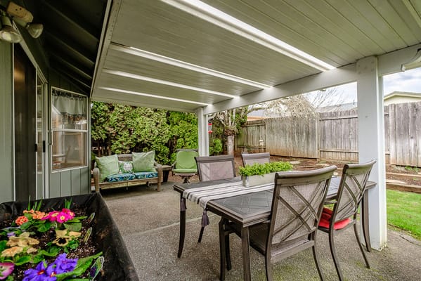 Outdoor patio area with seating and garden