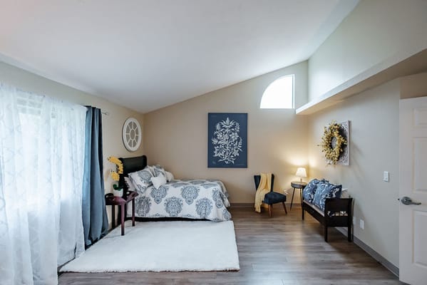 Bright and inviting resident room with a bed and seating area