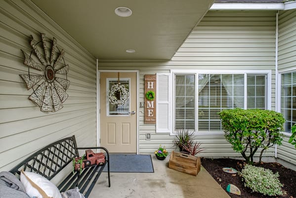 Welcoming entrance with a bench and decorative accents