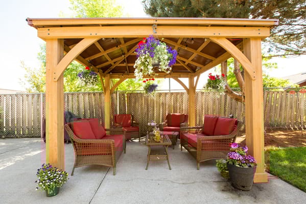 Outdoor gazebo seating area with flowers