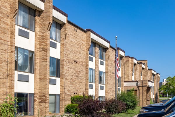 Exterior view of the facility building with flag