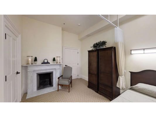 Cozy private resident room with fireplace and chair